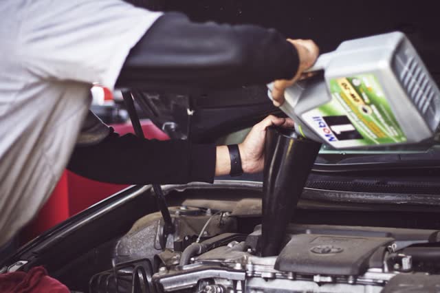 Mechanic performing oil change